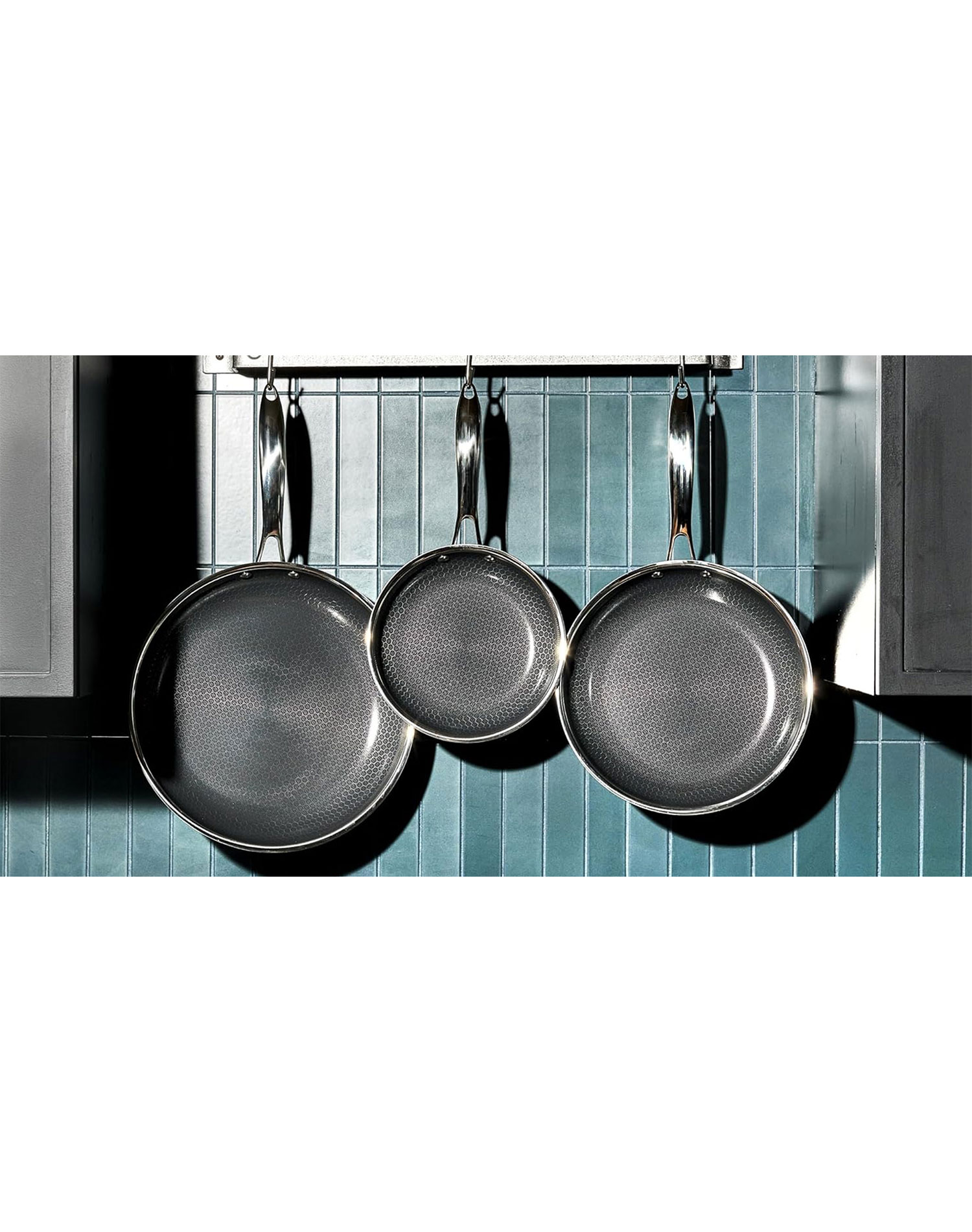 hexclad black friday sale: hexclad pans hanging above a stove